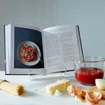 A cook book on the table with ingredients at its front - PRC Book Printing