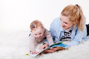 a mom and a child reading children's book